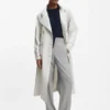 Belted coat with double-breasted closure