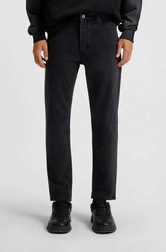 Black tapered-fit jeans in grain-effect denim Black tapered-fit jeans in grain-effect denim