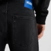 Black tapered-fit jeans in grain-effect denim Black tapered-fit jeans in grain-effect denim