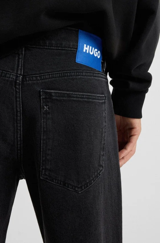 Black tapered-fit jeans in grain-effect denim Black tapered-fit jeans in grain-effect denim