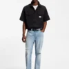Blue tapered-fit jeans in distressed denim