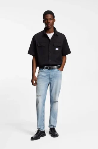 Blue tapered-fit jeans in distressed denim