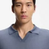 Cotton-blend knit polo with horizontal stripe.