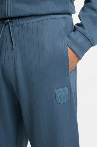 Cotton-blend tracksuit bottoms with drop-needle stripe