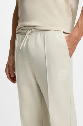 Cotton-blend tracksuit bottoms with tennis-themed logo Cotton-blend tracksuit bottoms with tennis-themed logo