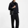 Grained reporter bag with stacked-logo trim