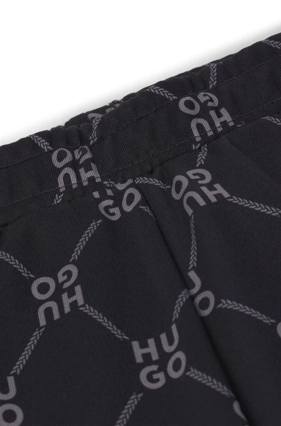 Kids’ loose-fit tracksuit bottoms with stacked-logo print Kids’ loose-fit tracksuit bottoms with stacked-logo print