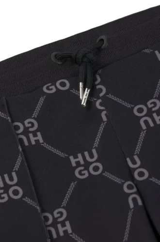 Kids’ loose-fit tracksuit bottoms with stacked-logo print