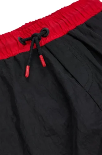 Kids’ swim shorts with vertical logo print