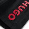 Kids’ swim shorts with vertical logo print