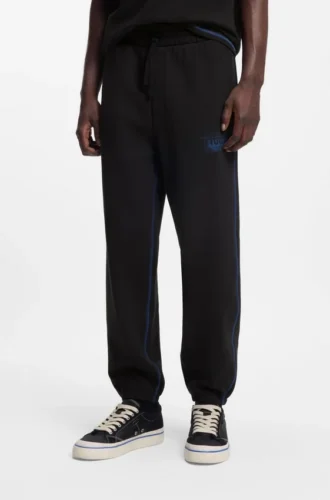 Logo-artwork tracksuit bottoms in cotton terry