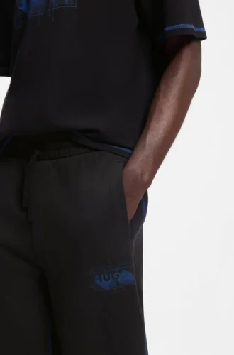 Logo-artwork tracksuit bottoms in cotton terry