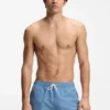 Micro-print swim trunks with logo patch