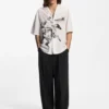 Pleat-front pants with whipstitch details