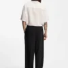 Pleat-front pants with whipstitch details
