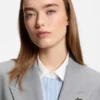 Relaxed-fit blazer with enamel flower brooch