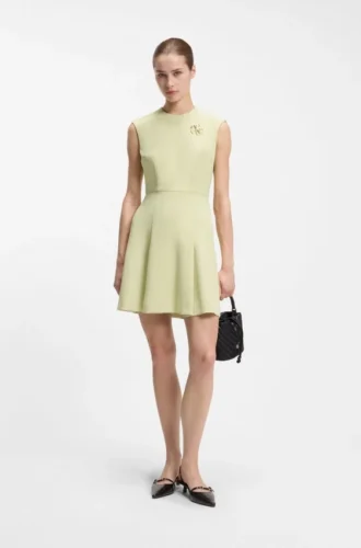 Sleeveless dress with gold-tone flower brooch