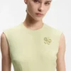 Sleeveless dress with gold-tone flower brooch Sleeveless dress with gold-tone flower brooch
