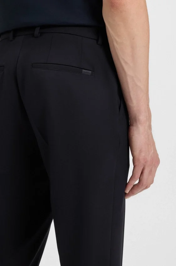 Slim-fit trousers in micro-patterned stretch fabric Slim-fit trousers in micro-patterned stretch fabric