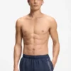 Swim shorts with repeated logos