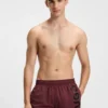 Swim shorts with vertical logo print
