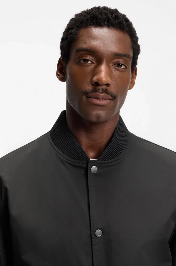 Water-repellent jacket with monogram-patterned sleeves Water-repellent jacket with monogram-patterned sleeves
